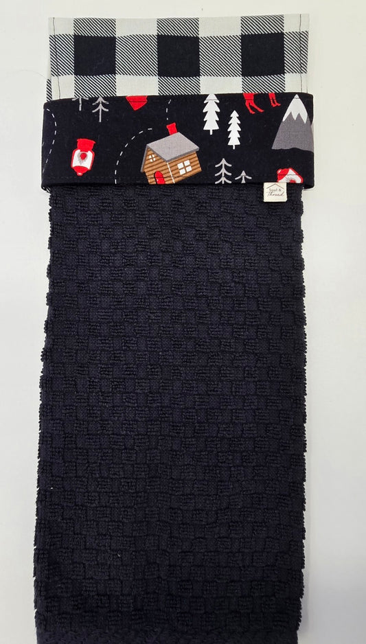 Black hanging towel with Cabin Trail woodland print band and buffalo plaid topper
