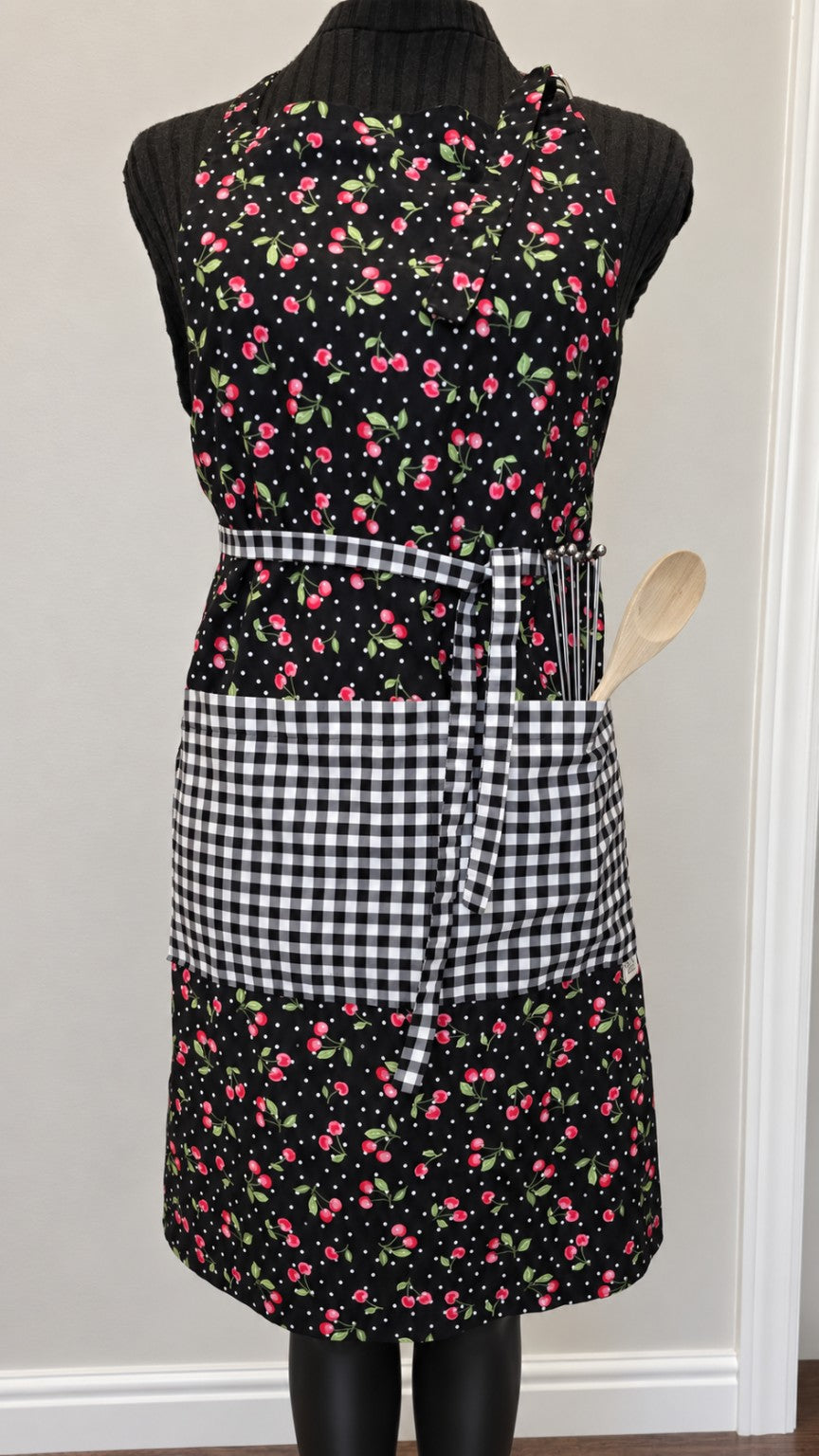 Cherries Jubilee handmade full-length apron with cherry print and black-and-white gingham pocket
