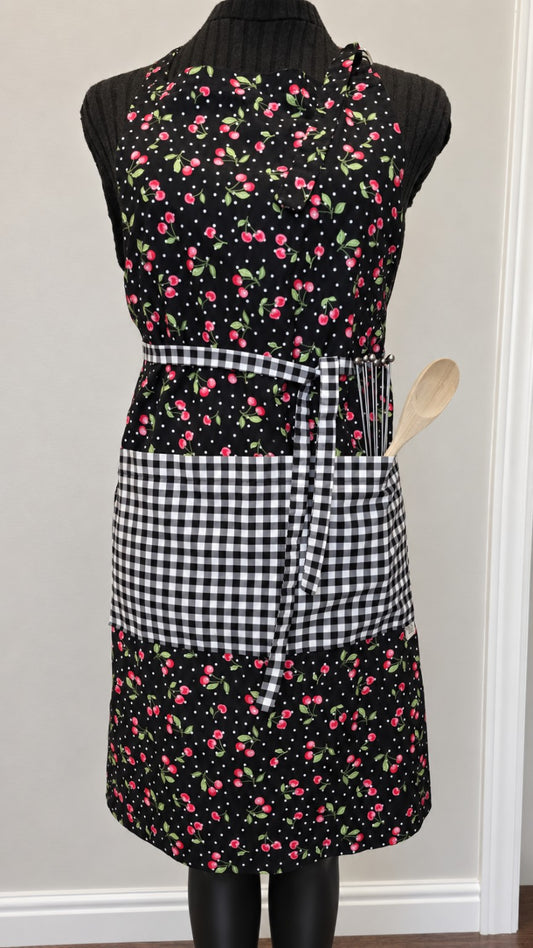 Cherries Jubilee handmade full-length apron with cherry print and black-and-white gingham pocket