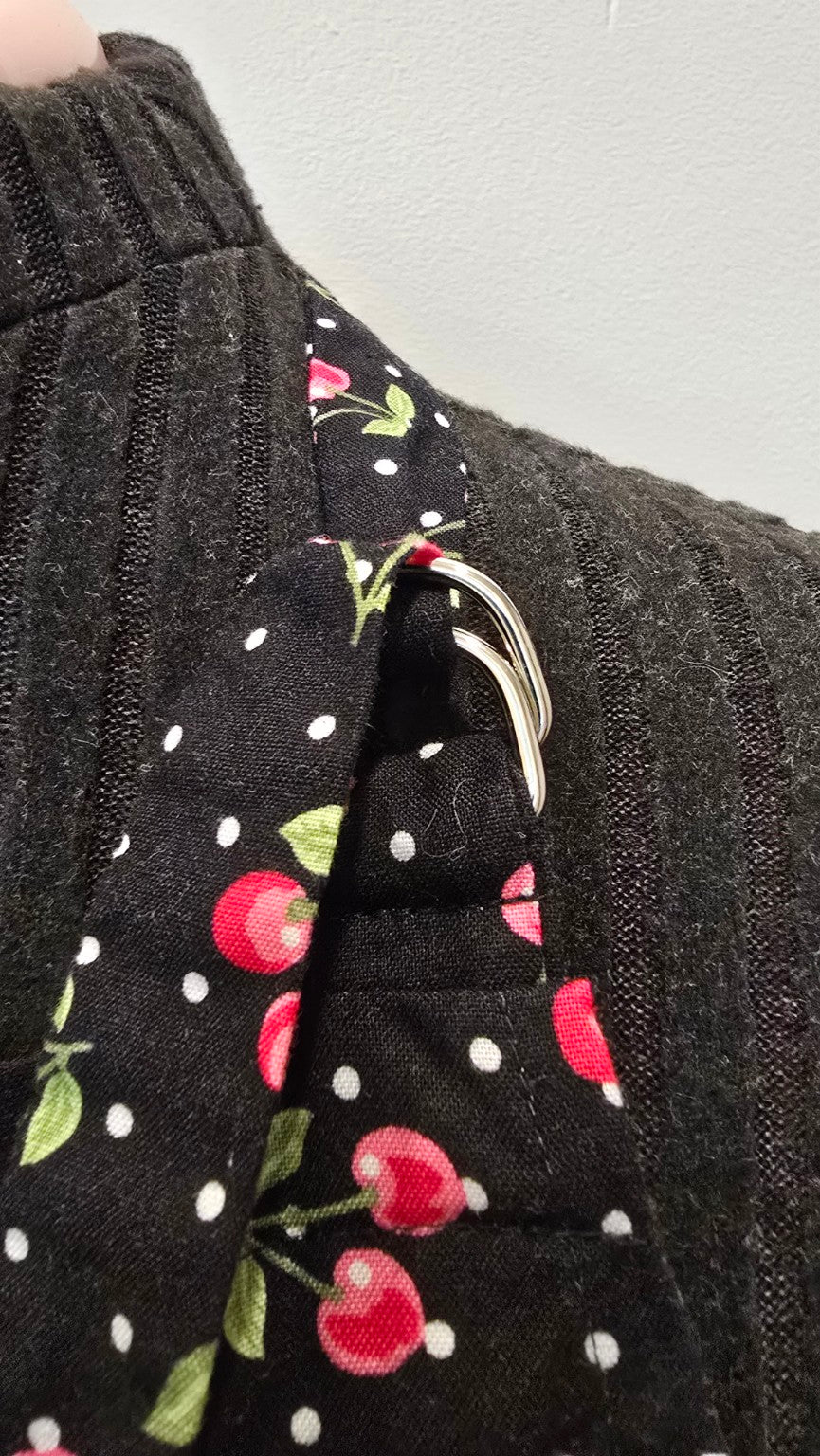 Close-up of adjustable metal ring neck strap on Cherries Jubilee apron