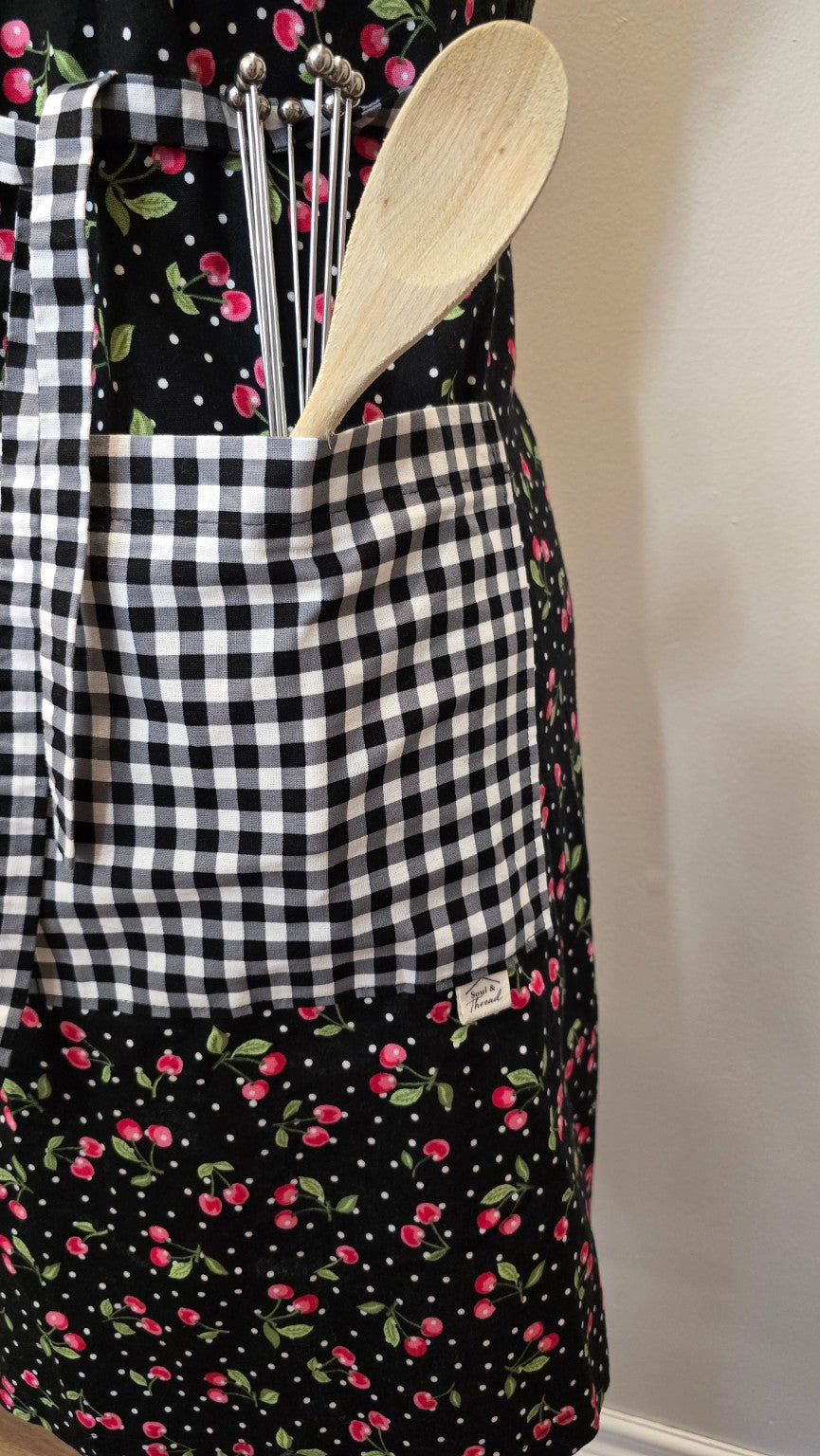 Close-up of black-and-white gingham pocket on Cherries Jubilee apron