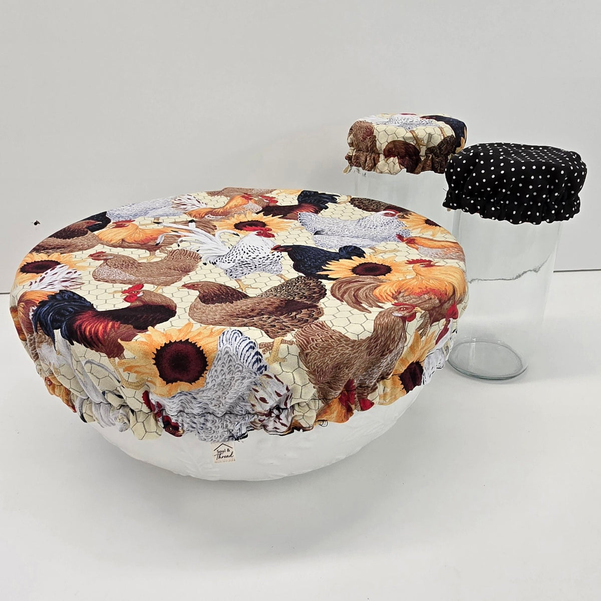 Hen House reusable bowl cover on a large bowl with coordinating jar covers