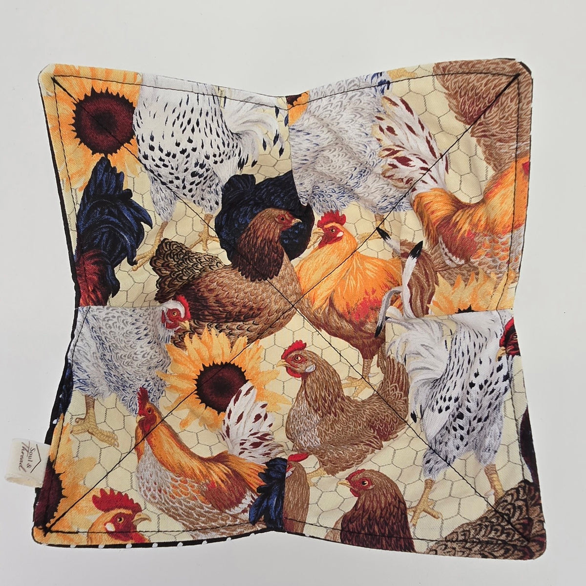 Hen House reversible bowl cozy laid flat showing chicken and sunflower print