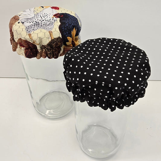 Two handmade fabric jar bonnets, chicken print and black polka dot
